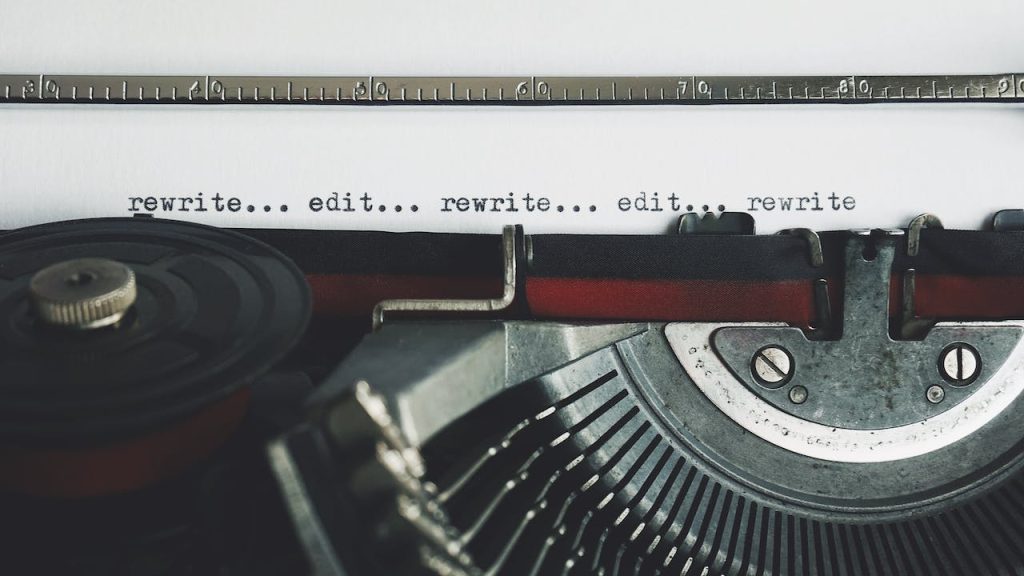 A typewriter writing the words "edit" and "rewrite" repeatedly