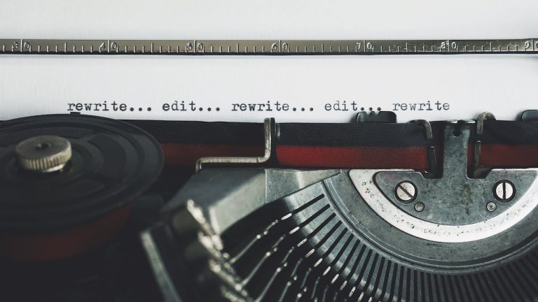 A typewriter writing the words "edit" and "rewrite" repeatedly